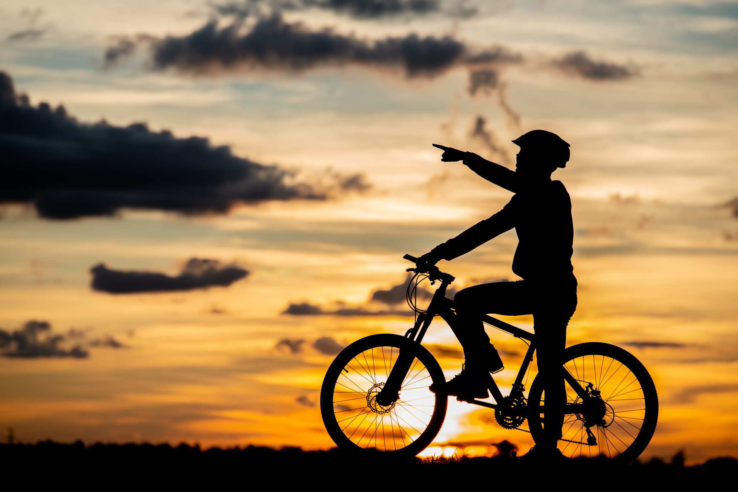 Cyclist resting silhouette at sunset. active outdoor sport conce